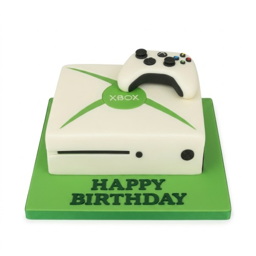 White and green Xbox console cake with an edible Xbox controller on top, on a green cake board with 'Happy Birthday' written.