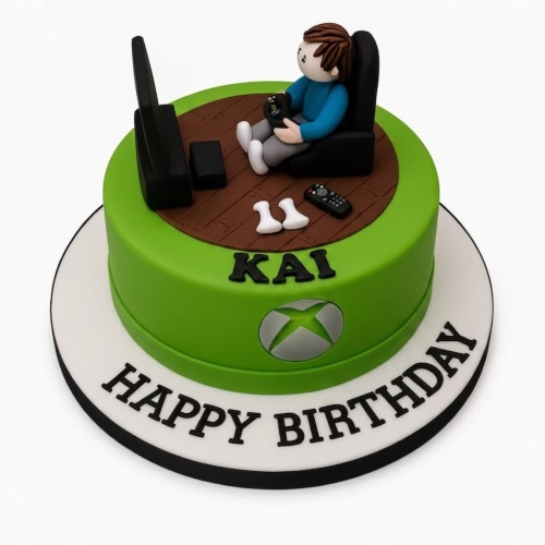 Green round Xbox theme birthday cake with fondant gamer figure, TV, controllers, and personalised message.