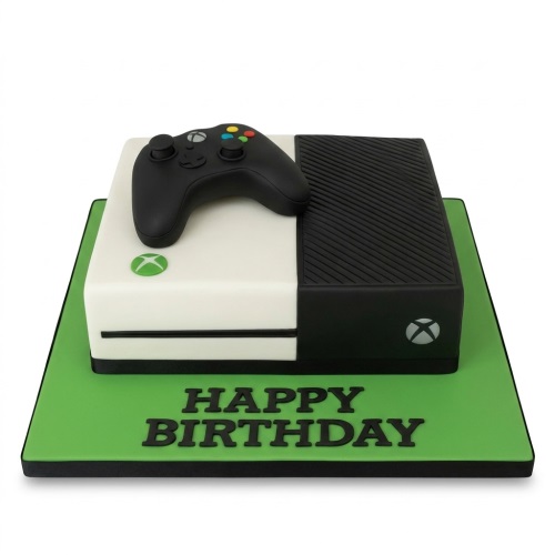 Xbox console and controller birthday cake on a green board with 'Happy Birthday' message.