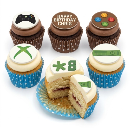 Six cupcakes with gaming-themed toppers, including an Xbox controller, Xbox logo, and console design, with one cupcake showing a custom age '8' topper.