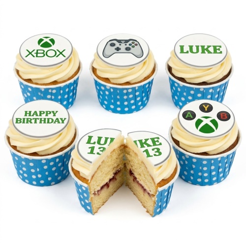 Vanilla cupcakes with white frosting and Xbox themed edible toppers in blue polka dot cases