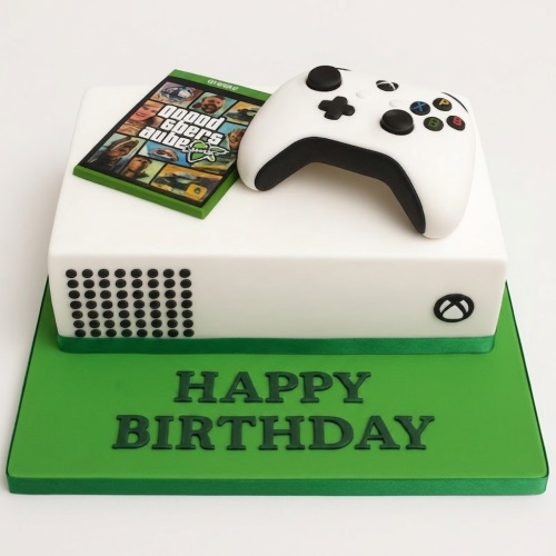 White Xbox console themed birthday cake with edible controller and Grand Theft Auto game