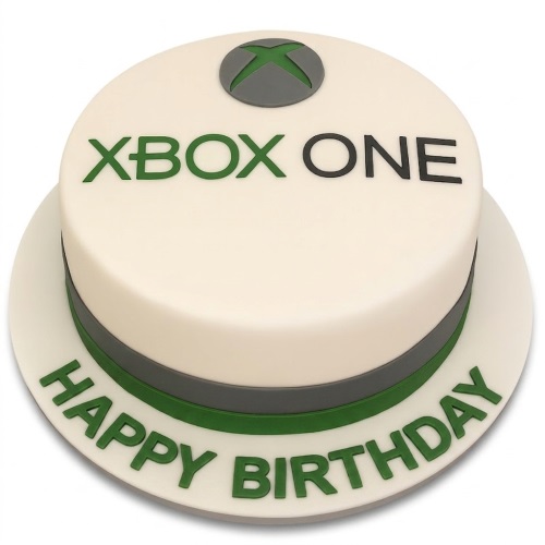 Round white Xbox One birthday cake with green logo, black text, and "Happy Birthday" on the board.