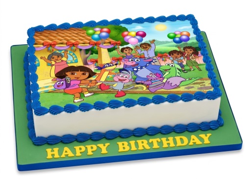 Rectangular Dora the Explorer birthday cake with Dora, Boots, and friends on top, blue icing borders, and a 'Happy Birthday' message.