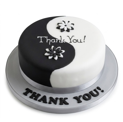 Round black and white Yin Yang Thank You cake with sugar flowers and 'Thank You!' message.