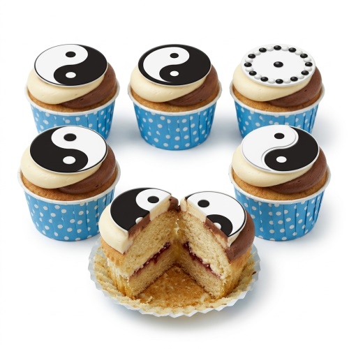 Yin Yang themed cupcakes with black and white toppers and dual-toned frosting in blue polka dot cases.