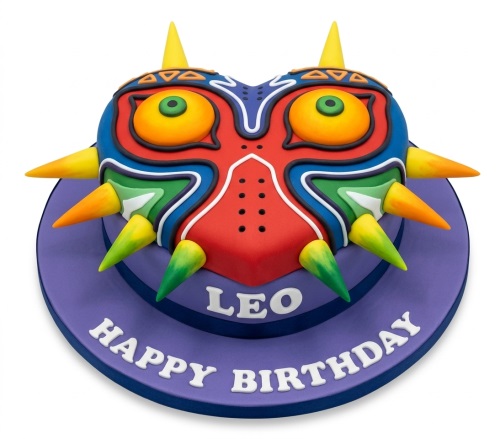 Vibrant Majora's Mask themed birthday cake with colourful spikes and eyes, on a purple base.