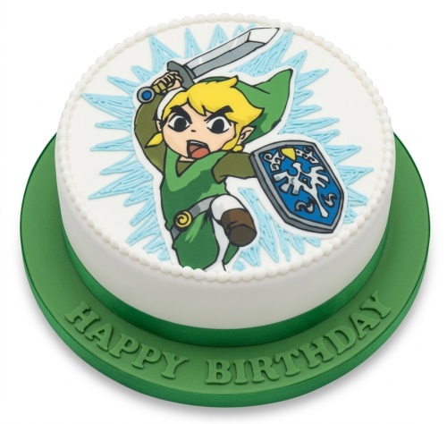 Round white birthday cake with an edible image of Link from The Legend of Zelda holding a sword and shield.