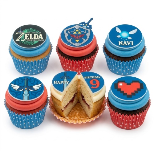 Six Legend of Zelda themed cupcakes with blue and red frosting, featuring game logos, a shield, sword, Navi, and a pixel heart, with one cupcake cut showing "Happy Birthday 9".