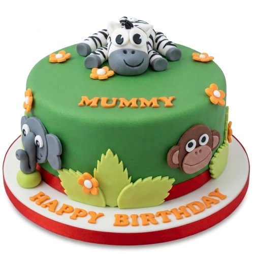 Round green jungle theme birthday cake with fondant zebra, elephant, monkey, flowers, and leaves.